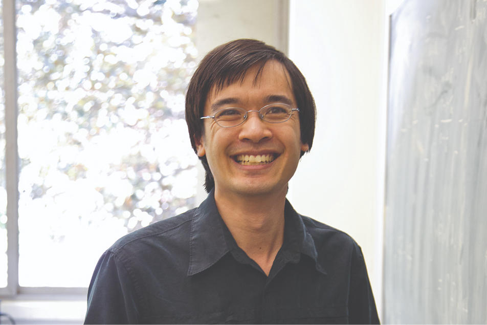 UCLA mathematician and Fields Medal winner Terence Tao smiling near a chalkboard
